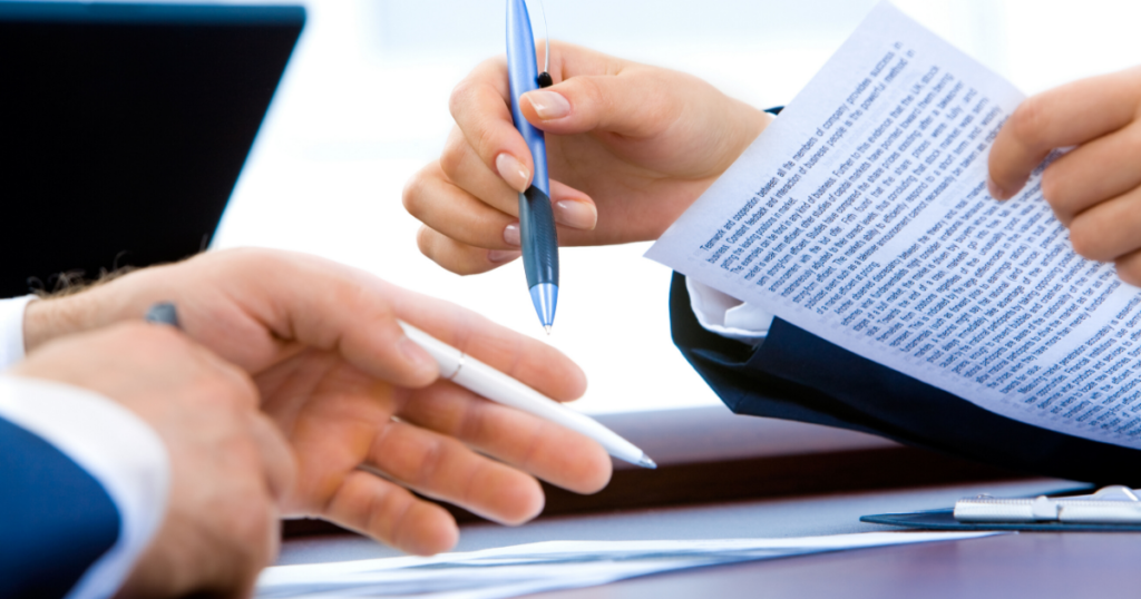 Close-up of a business contract with a pen, symbolizing the comprehensive services offered by Meritus Group for buying and selling businesses.