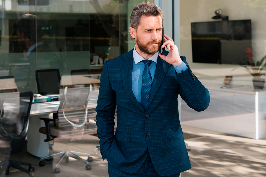 Businessman engaged in a phone conversation, signifying communication and dealmaking.